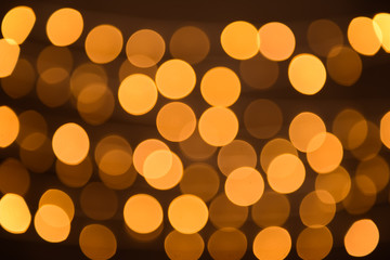 Blurred view of beautiful lights on dark background