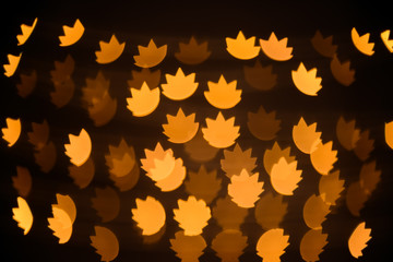 Blurred view of beautiful lights on dark background