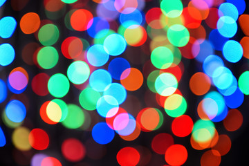 Blurred view of beautiful lights on dark background