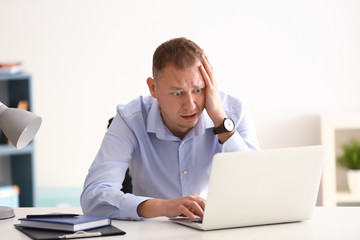 Man having panic attack at workplace in office