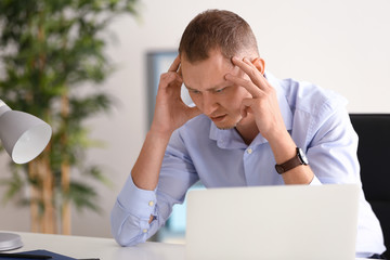 Man having panic attack at workplace in office