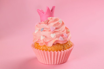 Tasty cupcake on color background