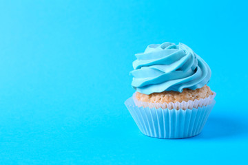 Tasty cupcake on color background