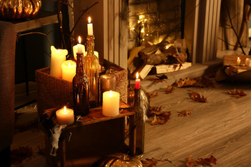 Burning candles as decor for Halloween party in room