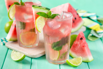 Watermelon lemonade with lime and mint, wood background, copy space