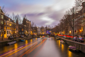 View on romantic canal Keizergracht  in Amsterdam at night with city light and reflection on water