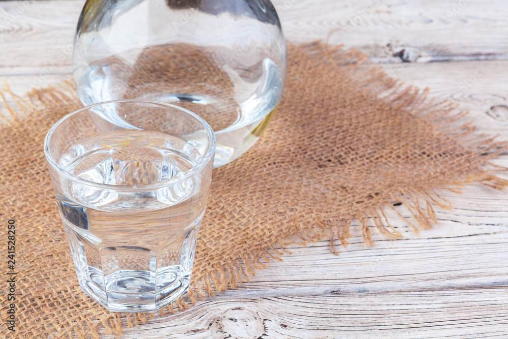 Wall mural glasses of water on a wooden table.