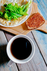 Fried egg in the form of a pancake, wooden cutting board. Breakfast, still life.