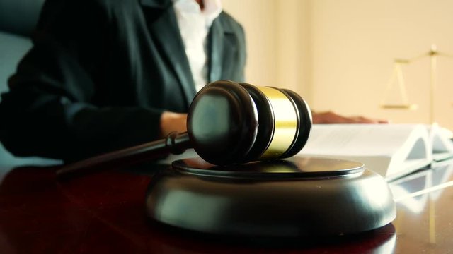 Judge hand banging a gavel .