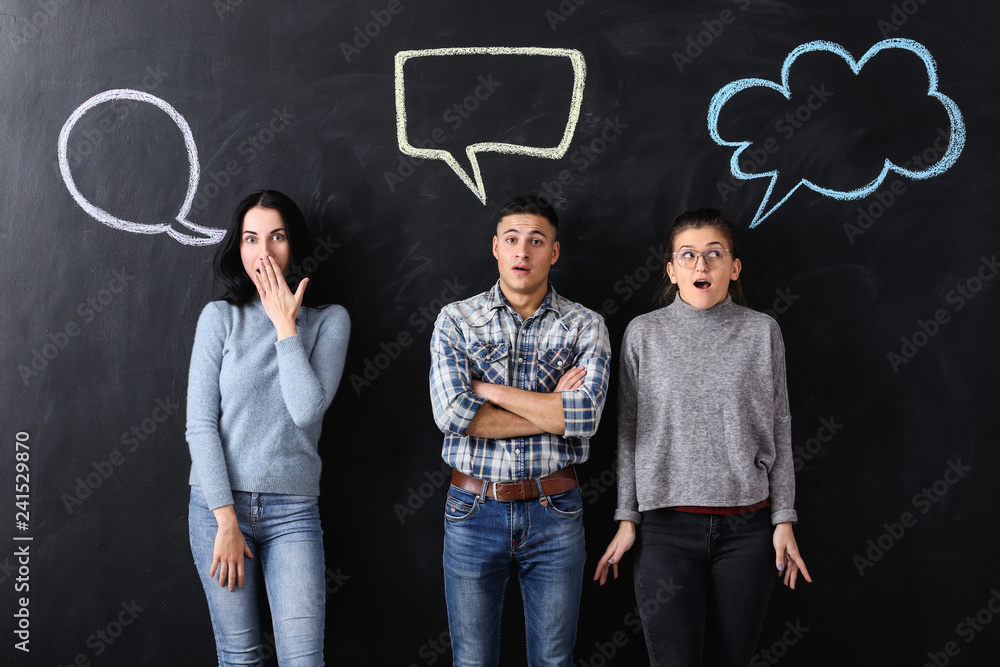 Wall mural shocked people and blank speech bubbles on dark background