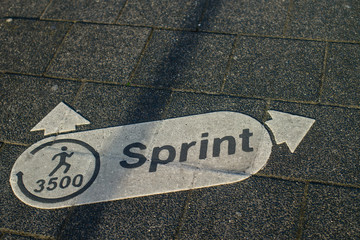 sprint running direction arrow on asphalt