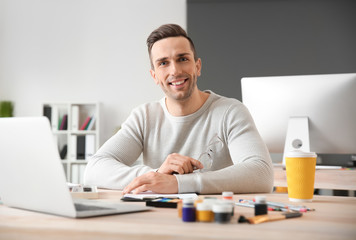 Portrait of young designer in office