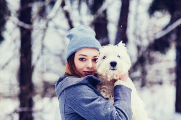 Portrait of a woman with her beautiful dog hugging outdoors 