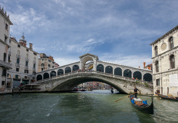 Fototapeta na wymiar Venice , Italy-may 25,2013:gondolas, tourists and panoramic view