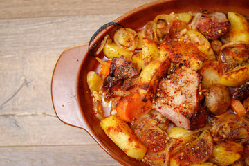 Stew with homemade smoked meat and vegetables in ceramic bowl. Sweet and plain potato, carrot, champignon mushrooms garlic and onion.