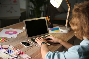 Young designer working late in evening