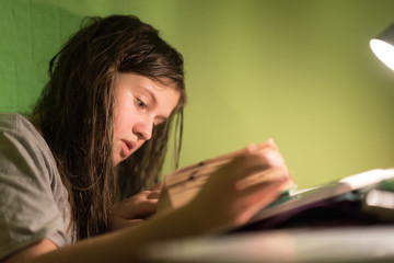 Girl with wet long hair doing homework