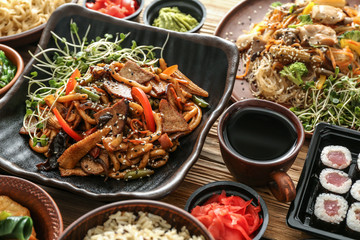 Assortment of Chinese food on wooden table