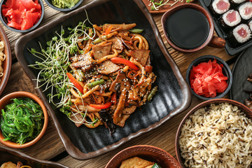 Assortment of Chinese food on wooden table