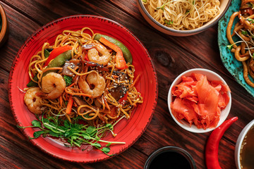 Assortment of Chinese food on wooden table