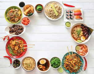 Assortment of Chinese food on white wooden table