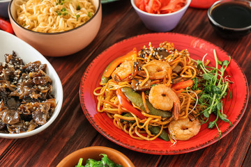 Assortment of Chinese food on wooden table