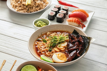 Assortment of Chinese food on white wooden table