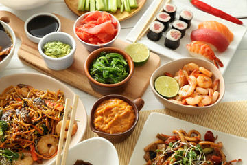Assortment of Chinese food on white table
