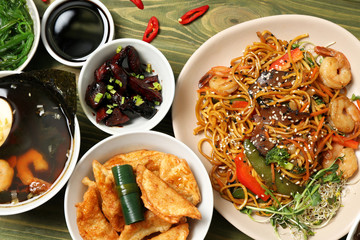 Assortment of Chinese food on wooden table