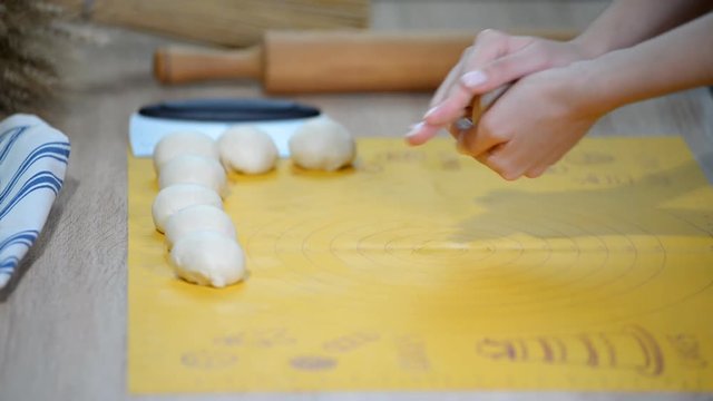 Woman roll out the dough on the wooden cutting board. Step by step recipe of homemade tortillas.