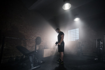 Weightlifter flipping one-handed dumbbell