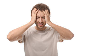 Young man suffering from headache on white background