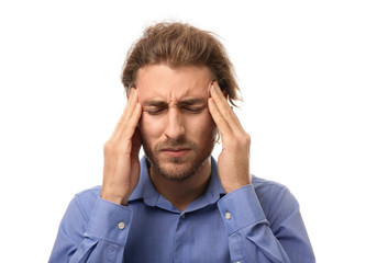 Naklejka premium Young man suffering from headache on white background