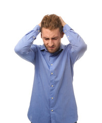 Young man suffering from headache on white background