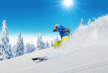 Young man skiing on piste