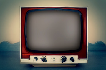 A retro vintage TV from the 1970s, showing a convex grey screen. Front shot.
