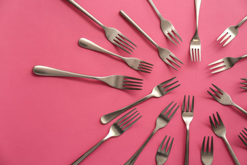 Set of forks on color background