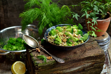 Salad with groats and vegetables on a wooden background