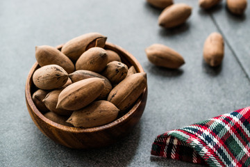 Pecan Nuts with Shell in Wooden Bowl / Walnuts.