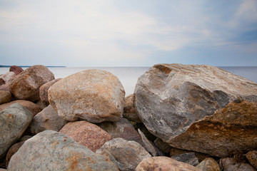 Fototapeta na wymiar A pile of stones on the lake.