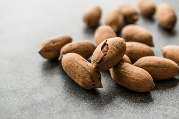 Pecan Nuts with Shell in Wooden Bowl / Walnuts.