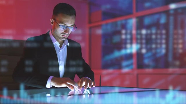 The businessman working with a display on the hologram background
