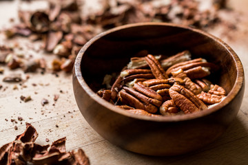 Peeled Pecan Nuts in Wooden Bowl without Shell / Walnuts.