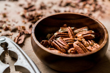 Peeled Pecan Nuts in Wooden Bowl without Shell / Walnuts.