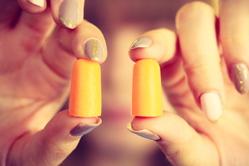Woman holding protective earplugs