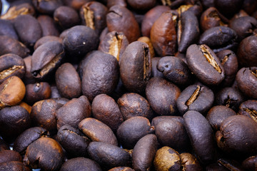 Coffee beans background texture with copy space for text. Royalty high-quality free stock macro photo image of roasted black coffee beans, coffee beans background. Close-up or macro photo coffee bean