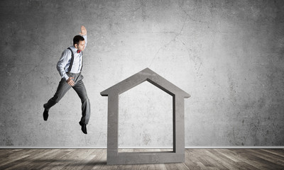 Stone home silhouette in empty room as symbol for real estate insurance