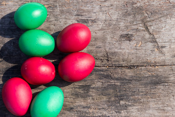 Painted Easter eggs on rustic wooden background