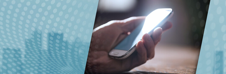 Hand holding a phone, panoramic banner
