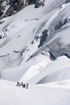 Mountaineers ascending to Mont Blanc in Chamonix, France. Vertical image